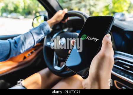 Woman hand holding iphone Xs with logo of instagram application in a car. Instagram is largest and most popular photograph social networking. Stock Photo