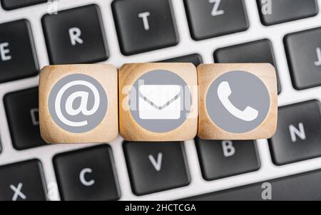 Wood cube symbol telephone, mail, address. Website page contact us or e-mail marketing concept Stock Photo