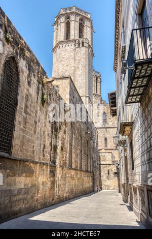 Small street in the gothic quarter in Barcelona with one of the towers of the cathedral Stock Photo