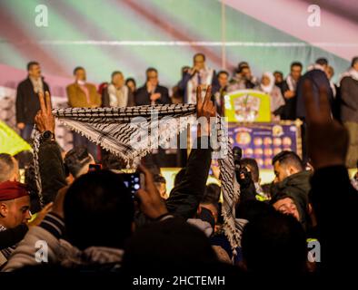 Gaza City, Gaza Strip, Palestine. 31st Dec, 2021. Gaza, Palestine. 31 December 2021. Palestinians gather at Palestine Square in Gaza City during a rally to mark the 57th anniversary of the establishment of the Palestinian National Liberation Movement of Fatah. Participants waved Fatah yellow flags and lighted a torch while shouting slogans in support of the Palestinians' struggle for independence and against the Israeli occupation. Similar rallies and celebrations took place in several West Bank towns and cities (Credit Image: © Ahmad Hasaballah/IMAGESLIVE via ZUMA Press Wire) Credit: ZUMA Pre Stock Photo