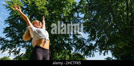 Young woman enjoying spring breeze in the park after sport. Stock Photo