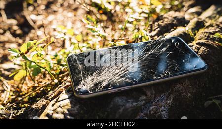 Broken screen smartphone outdoor after hiking Stock Photo