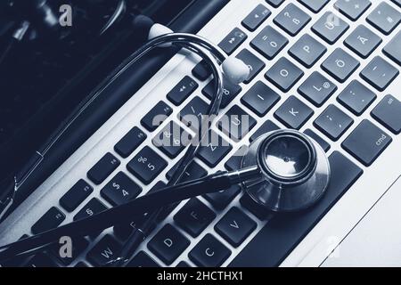 Stethoscope on laptop keyboard Stock Photo