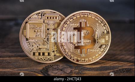 Golden Bitcoins on a wooden table Stock Photo