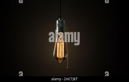 Vintage Edison lightbulb on dark background with bright yellow shining wire Stock Photo