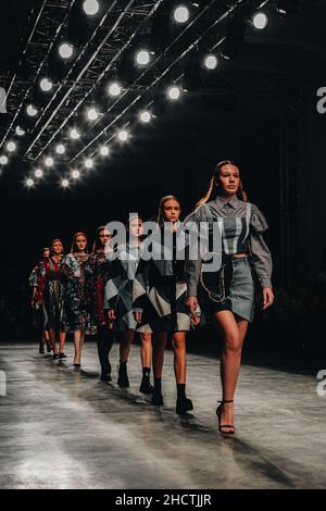 Young fashion models walking the final run at a Fashion show during Fashion Week Stock Photo