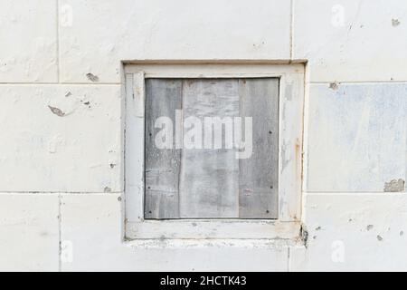 old weathered cement wall background with window Stock Photo