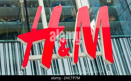 H&M logo on a store. H & M Hennes & Mauritz AB is a Swedish multinational retail-clothing company, known for its fast-fashion clothing. Stock Photo