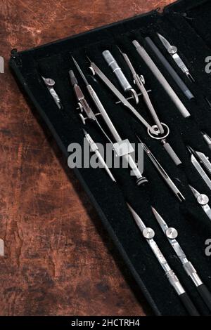 a box with a set of protractors on brown grungy table Stock Photo