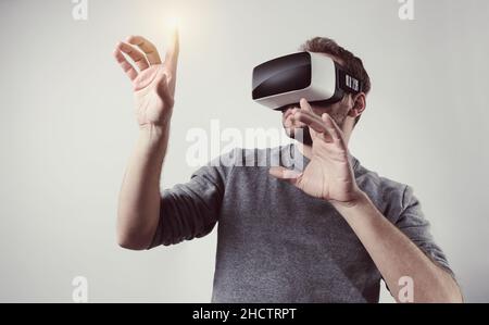 young man wearing Virtual Reality goggles VR Headset Stock Photo
