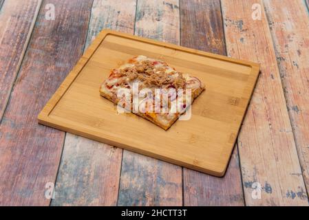 Soft tuna and onion pizza in a pan, with a highly hydrated dough and very little yeast for a highly digestible pizza. Stock Photo