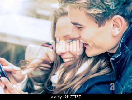 Couple in love having fun with a Smartphone Stock Photo