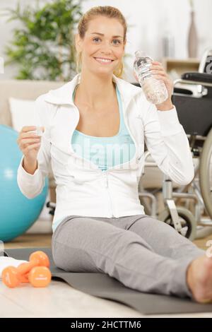 woman in a wheelchair stretching her legs Stock Photo
