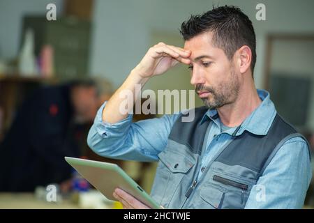 stressed manager holding a tablet Stock Photo