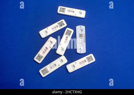 Quick testing for Covid-19 / SARS-CoV-2 infection concept: Several rapid antigen test kits showing a positive result (two lines) and negative result Stock Photo