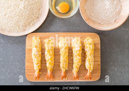 batter-fried prawns on wood board with ingredients Stock Photo