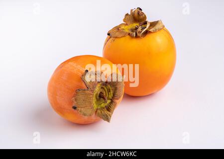 Two fresh persimmons isolated on white background, space for text Stock Photo