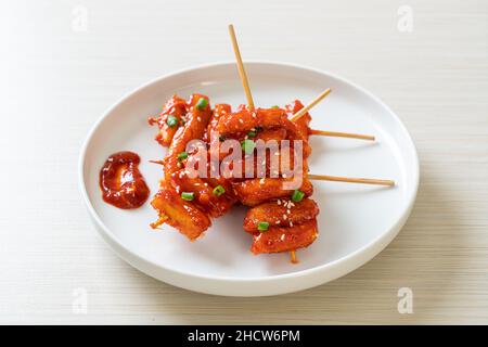 deep fried Korean rice cake (Tteokbokki) skewered with spicy sauce - Korean food style Stock Photo