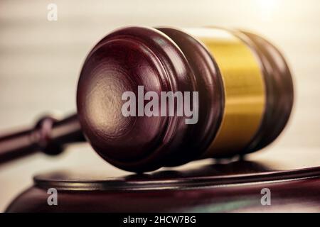 Close up of a judge gavel and law books in the background of a courtroom Stock Photo
