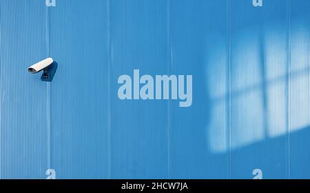 Security camera on the blue wall Stock Photo