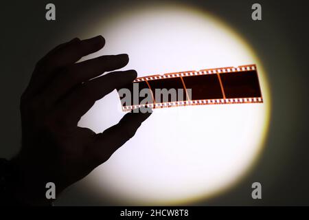 Hand holding 35mm film negatives Stock Photo
