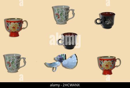Several cups on a light background. One of them is broken. Stock Photo