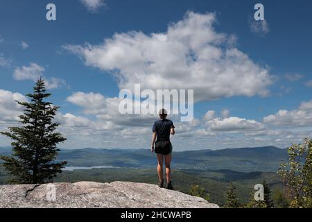 Girl hiker reaches the 2,556' summit of Pharaoh Mountain in the Adirondacks, NY, USA Stock Photo