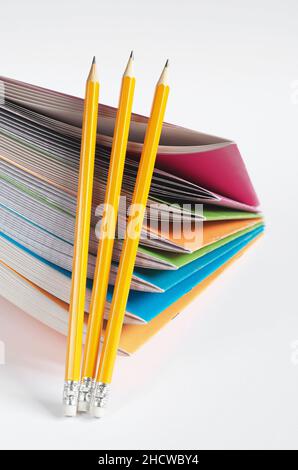 Pencils and colored school notebooks on white background. Education concept Stock Photo
