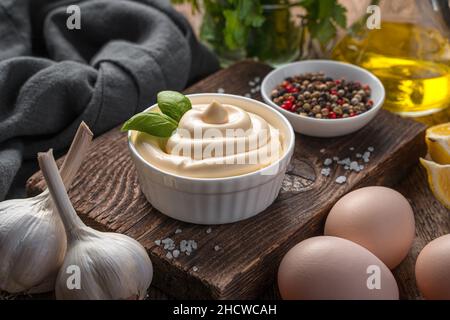 Mayonnaise, egg, butter and garlic on a wooden background. Stock Photo