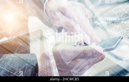 businessman using modern smartphone hands. Skyscraper office building on Double exposure background Stock Photo
