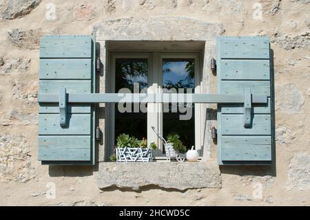 Authentic window with open blue wooden shutters in the small town in Croatia Stock Photo
