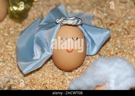 funny anthropized egg with angel face and virgin veil Stock Photo