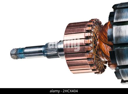 Detail of electric DC motor rotor isolated on white background. Copper commutator and coil wire winding attached to steel laminations  of engine part. Stock Photo