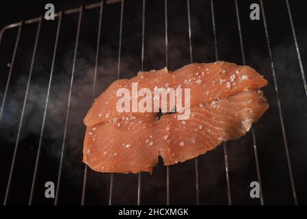 Smoked salmon fillets on a grill. Stock Photo