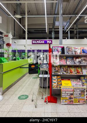 Turku, Finland - December 21, 2021: Vertical View of Cashier Counter in the Foreground and SilmaasEma Vision Clinic in the Background Stock Photo