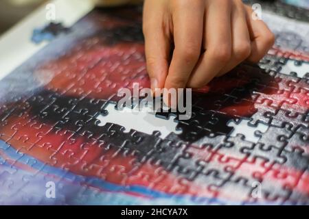 Assembling a puzzle, hands on puzzles, puzzle missing pieces ...