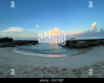 Beautiful early sunrise over beach and ocean in Cozumel, Mexico. Morning sun going up over the tropical ocean on an island in Riviera Maya. Stock Photo