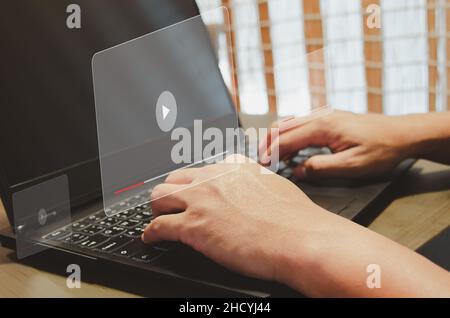 Man using computer laptop  virtual icon watching video on internet. modern Internet technology , Social Networking, online marketing, digital online. Stock Photo