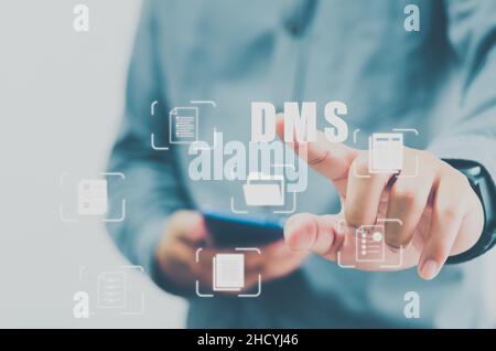 DMS Integrated Document Management System concept Online document database and digital file archiving software.man hands touch  virtual screen icon bu Stock Photo