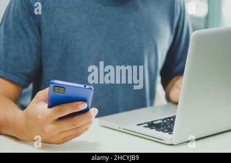 Men using mobile and computers are working on searching for information using internet technology.Modern concepts, business communication, investment Stock Photo