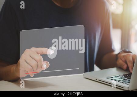 Man hand using computer laptop touch virtual search icon watching video on internet. modern Internet technology , Social Networking, online marketing, Stock Photo