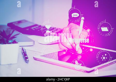 Hand use tablet digital virtual futuristic interface metaverse technology concept icon business. Stock Photo
