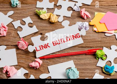 Conceptual display Link Building. Word for SEO Term Exchange Links Acquire Hyperlinks Indexed Building An Unfinished White Jigsaw Pattern Puzzle With Stock Photo