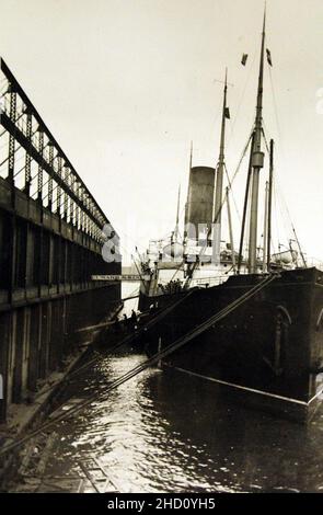 RMS Carpathia in New York harbour, with two tug boats at its bow. This ...