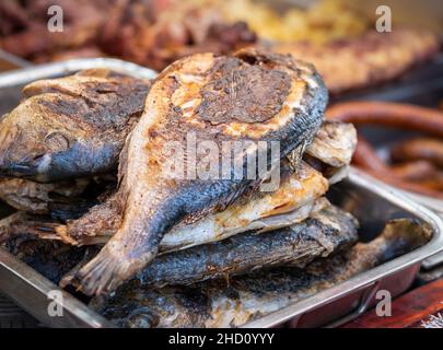 Roasted carp fish on a tray at e traditional street food festival in Romania. Stock Photo