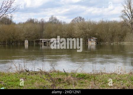 A small old wooden house affected by the flood. Stock Photo