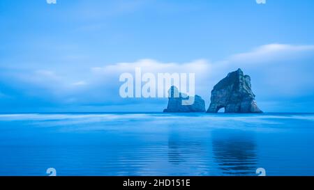 Panorama view of Archway Island on Wharariki beach at dawn, South Island, New Zealand. Stock Photo