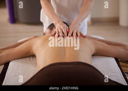 Male client getting professional back massage at spa center Stock Photo