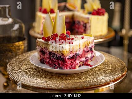 Slice of summer sponge cake with vanilla cream and fresh berries. Stock Photo