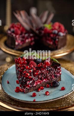 Delicious dark chocolate cake with raspberry and pomegranate Stock Photo